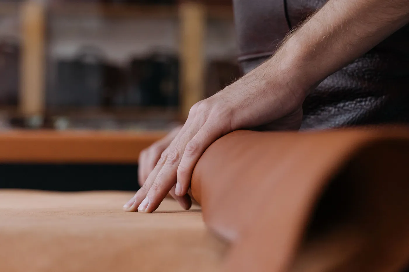A craftsman's hand on natural leather